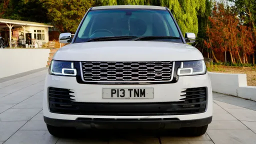 front view of white range rover limousine with silver front grill
