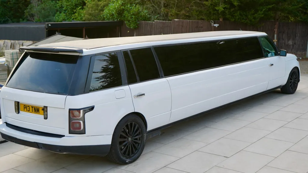 Right side view of white range rover stretched limousine with tinted windows