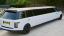 Right side view of white range rover stretched limousine with tinted windows