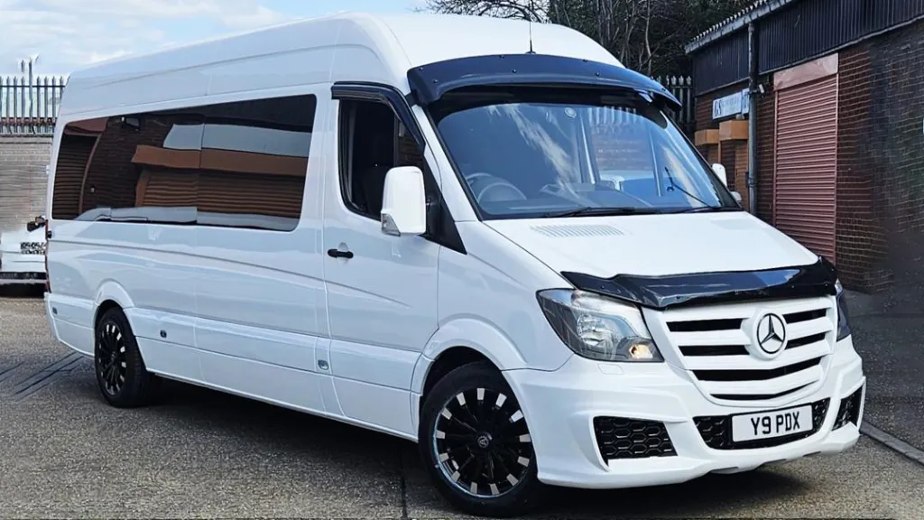 Classic Land Rover in Old English White decorated with pink wedding ribons and bows and side windows open