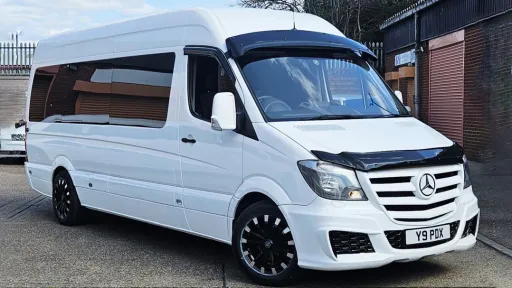 Classic Land Rover in Old English White decorated with pink wedding ribons and bows and side windows open