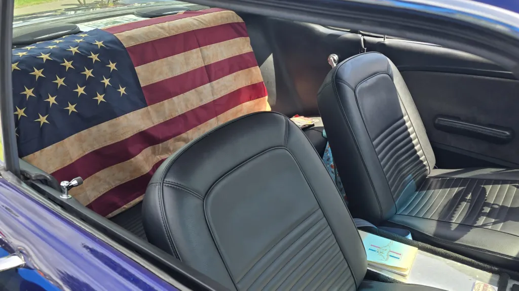 Ford Mustang Coupe rear interior seating of black leather with Maerican flag on rear seat