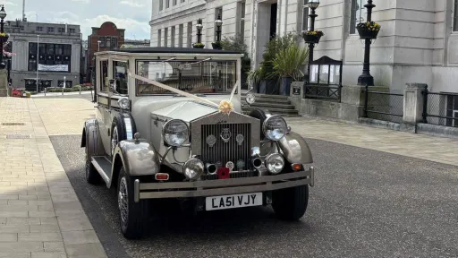 Imperial Viscount Landaulette front view with lare vintage-style headlights and decorated with ribbons and bow