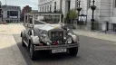 Imperial Viscount Landaulette front view with lare vintage-style headlights and decorated with ribbons and bow