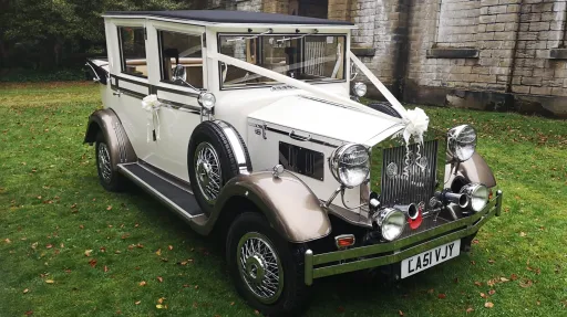 Imperial Viscount Landaulette park on green grass and decorated with white ribbons