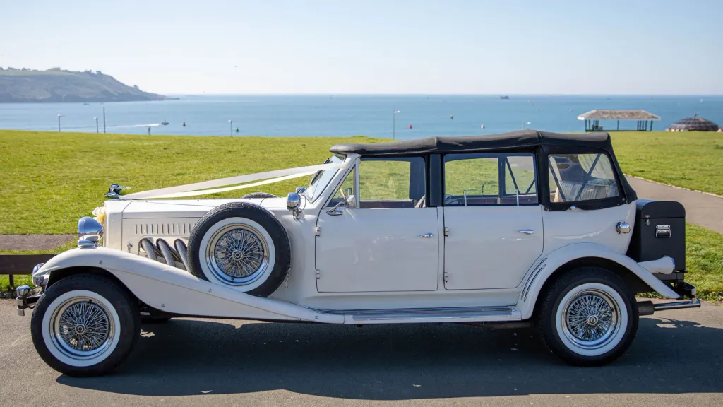 White vintage Beauford left side with black soft top roof closed