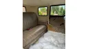 Interior Badsworth in light dark champagne colour leather rear bench seat with white fluffy carpet on the floor