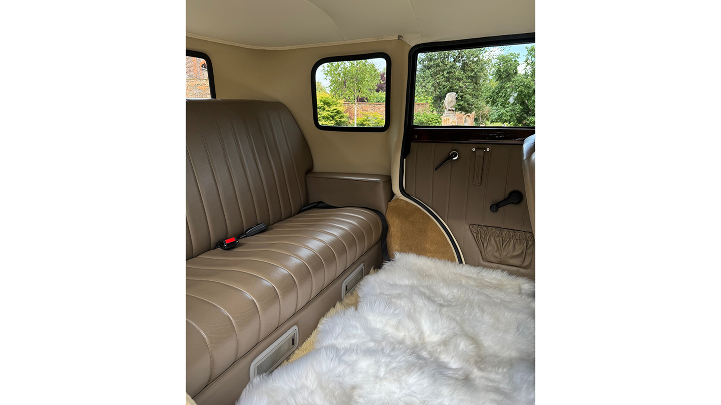Interior Badsworth in light dark champagne colour leather rear bench seat with white fluffy carpet on the floor