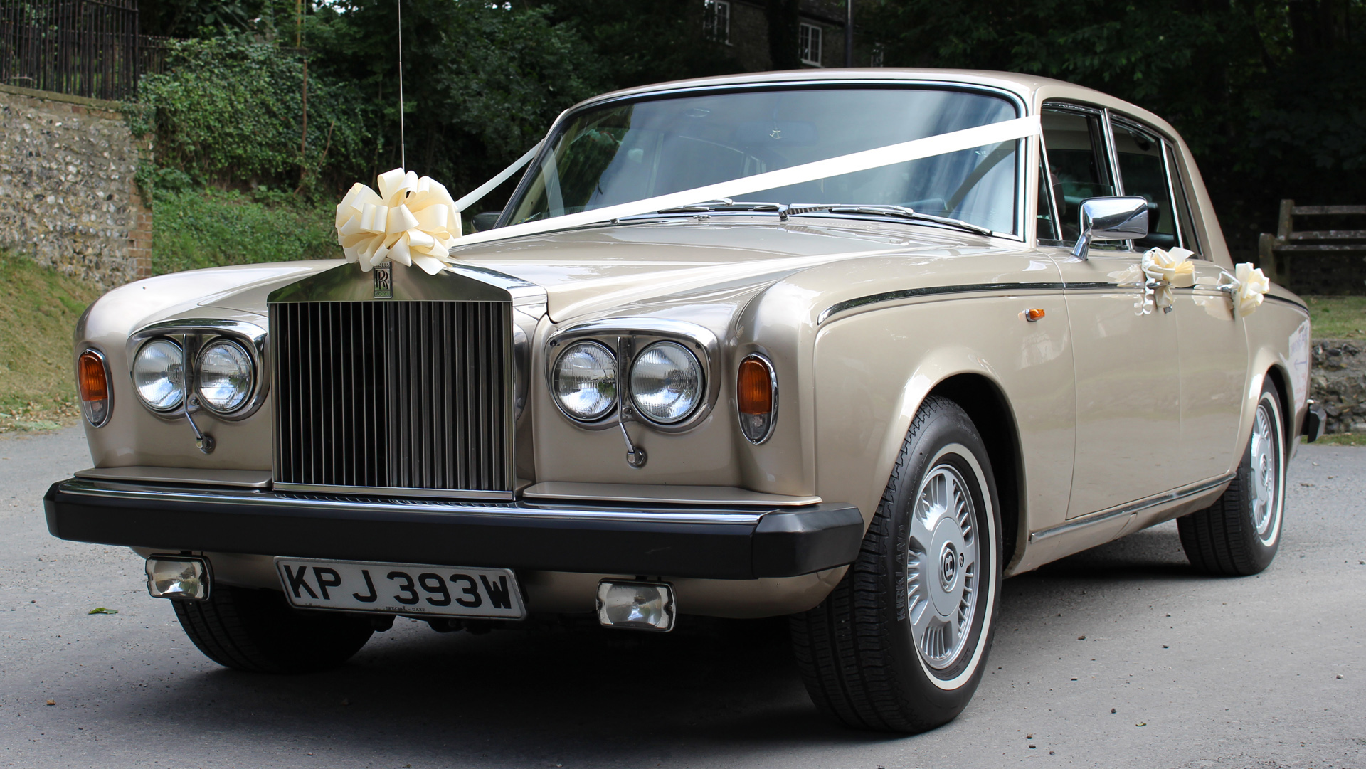 Rolls-Royce Silver Shadowin champagne gold coachwork with a large Ivory bow on top of the large chrome front grill