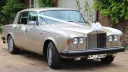 Champagne Gold classic Rolls-Royce Silver Shadow with white ribbon and bows on the door handles
