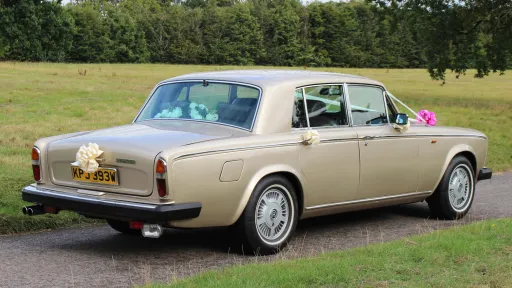 right side rear view of classic Rolls-Royce Silver Shadow with ribbons
