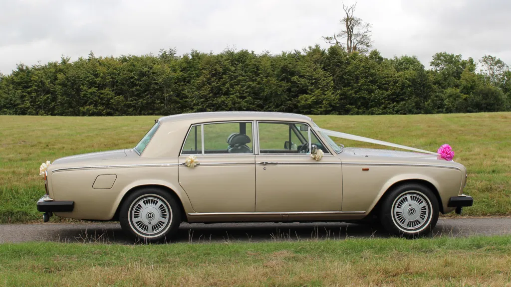 right side view of classis Rolls-Royce Silver Shadow in champagne gold coachwork