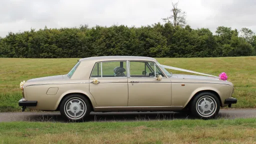 right side view of classis Rolls-Royce Silver Shadow in champagne gold coachwork
