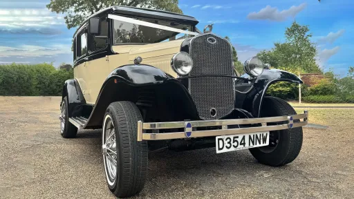Front view of Black and ivory Badsworth dressed with white ribbons across front bonnet