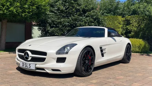 White Mercedes SLS AMG with soft top roof closed