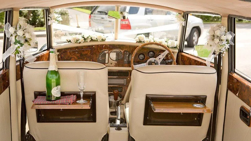 Vintage-style Royale Windsor interior with cream leather and wooden picnic tables