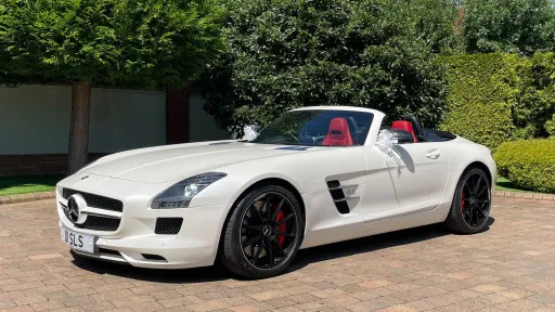 front left view White Mercedes SLS AMG Roadster with convertible roof open