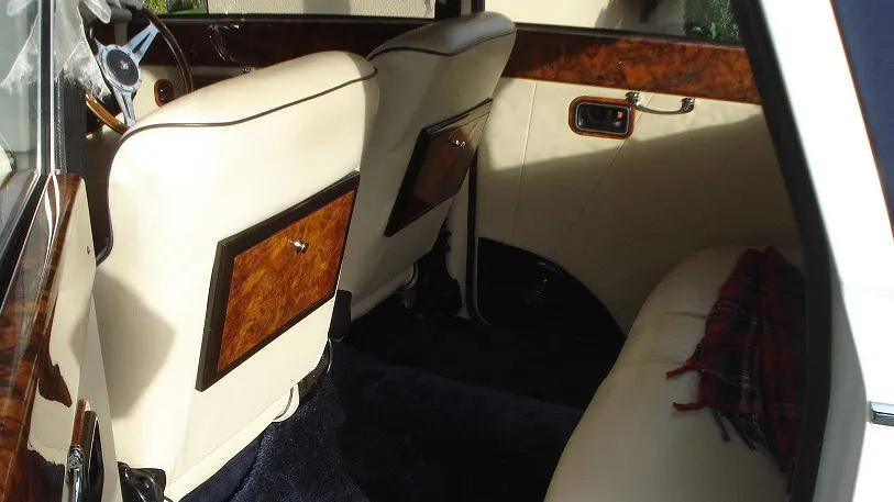 1930s vintage-style Royale Windsor rear interior space, cream letaher seats and blue carpet