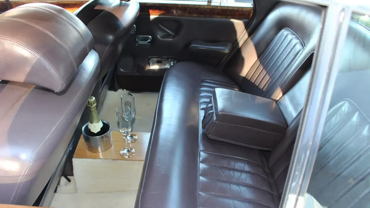 Brown leather rear interior seats inside classic Rolls-royce silver Shadow.