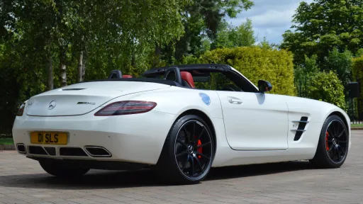 White Mercedes SLS AMG rear view with roof down