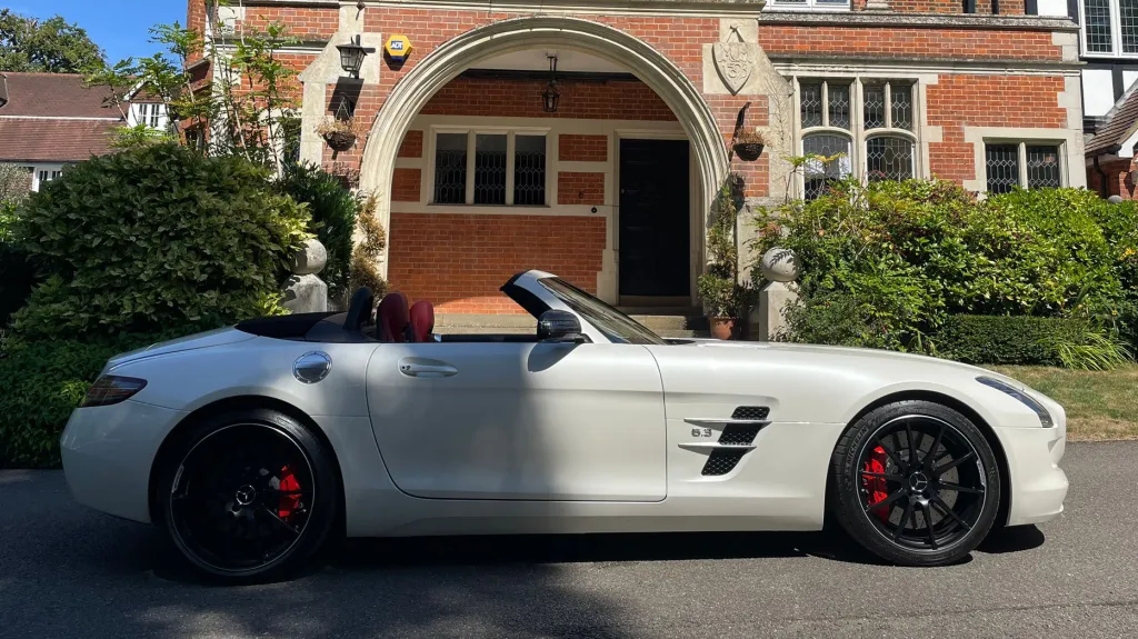 White Mercedes SLS AMG right side view in front of wedding venue