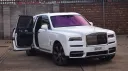 White Rolls-Royce cullinan with rear passenger door open