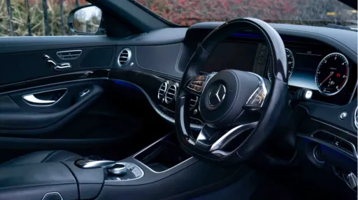 Front interior view of Mercedes S-Class showing black leather and AMG Line dashboard style