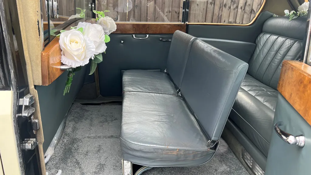 Austin Princess Limousine with additional two casual seats up, wooden door tops and white floral decoration inside the rear cabin