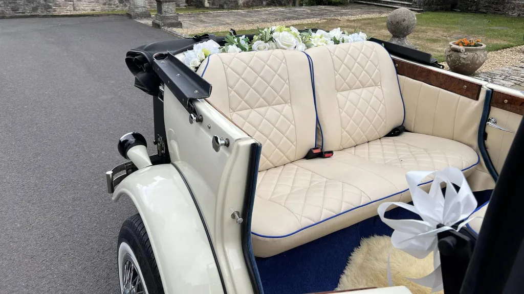 Beauford convertible with convertible roof open showing rear bench seats incream leather.