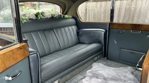 Austin Princess Limousine interior in Blue leather with white rug and floral decoration on the rear parcel shelf
