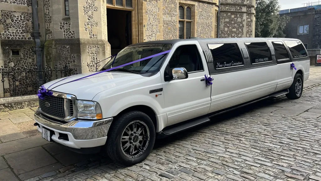 Ford Excursion Stretched Limousine decorated with cadbury purple ribbons parked in street in Southampton