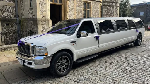 Ford Excursion Stretched Limousine decorated with cadbury purple ribbons parked in street in Southampton