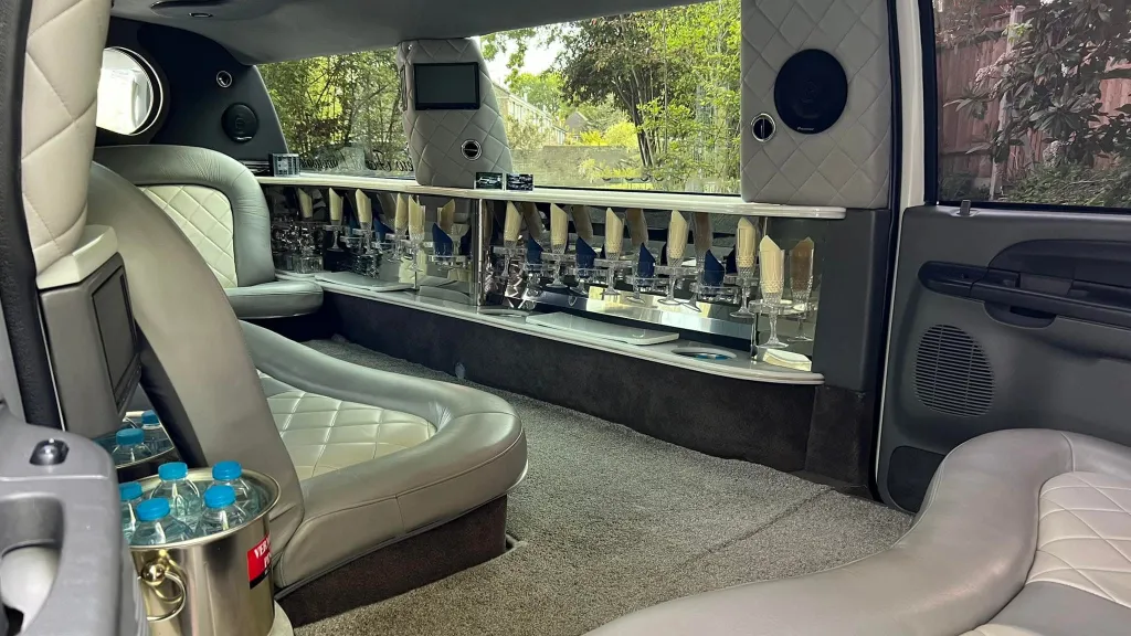 Ford Excursion Stretched Limousine interior with two tone silver interior, bar and TV