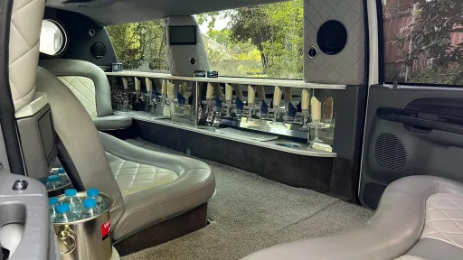 Ford Excursion Stretched Limousine interior with two tone silver interior, bar and TV