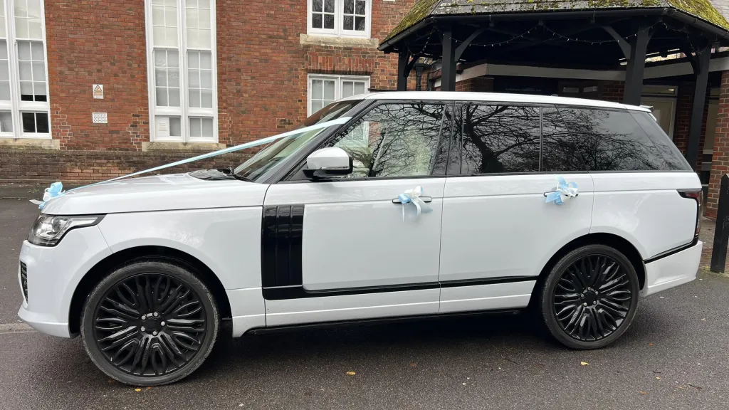 Left side view of White Range Rover dressed with pale green ribbons