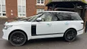 Left side view of White Range Rover dressed with pale green ribbons