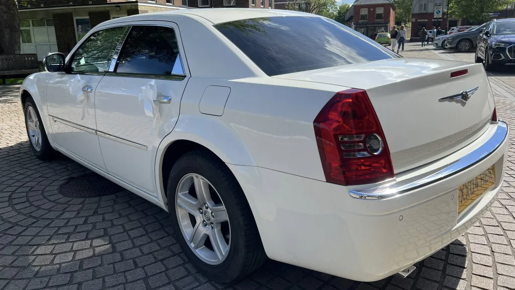 Rear left view of white chrysler 300c saloon