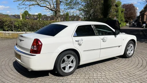 Rear right view of white chrysler 300c saloon