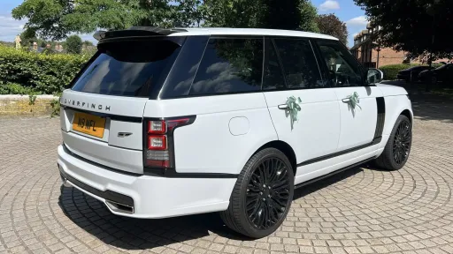 Right side view of White Range Rover Vogue by Overfinch with large black alloy wheels.