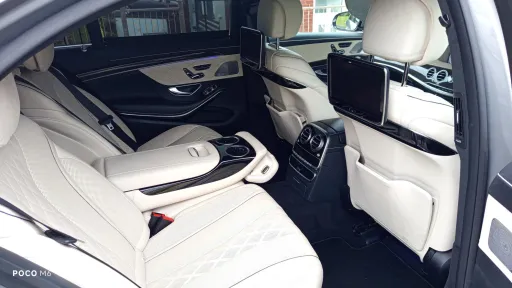 mercedes rear interior in cream leather, TV, and large leg room at the rear