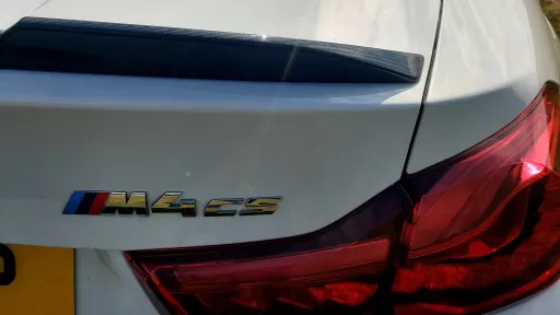 BMW badge on the right side of the rear bonnet with M4 cs badge