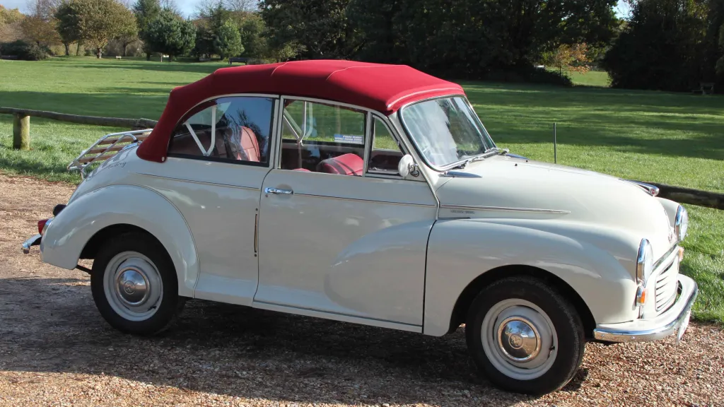 Classic Morris Minor with burgundy soft top roof closed up