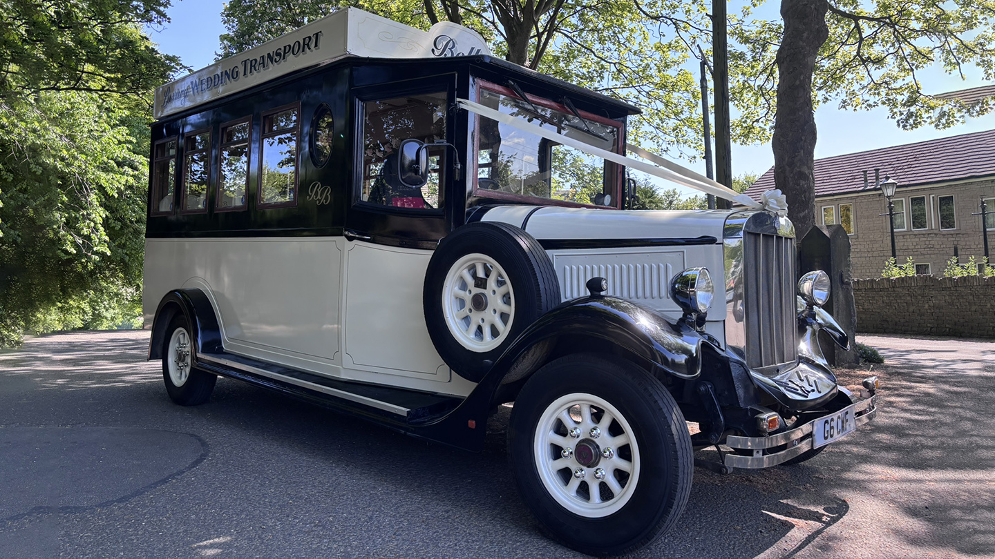 Vinatge Asquith Bus in Bl;ack and White with spare wheel mounted on side of the bus
