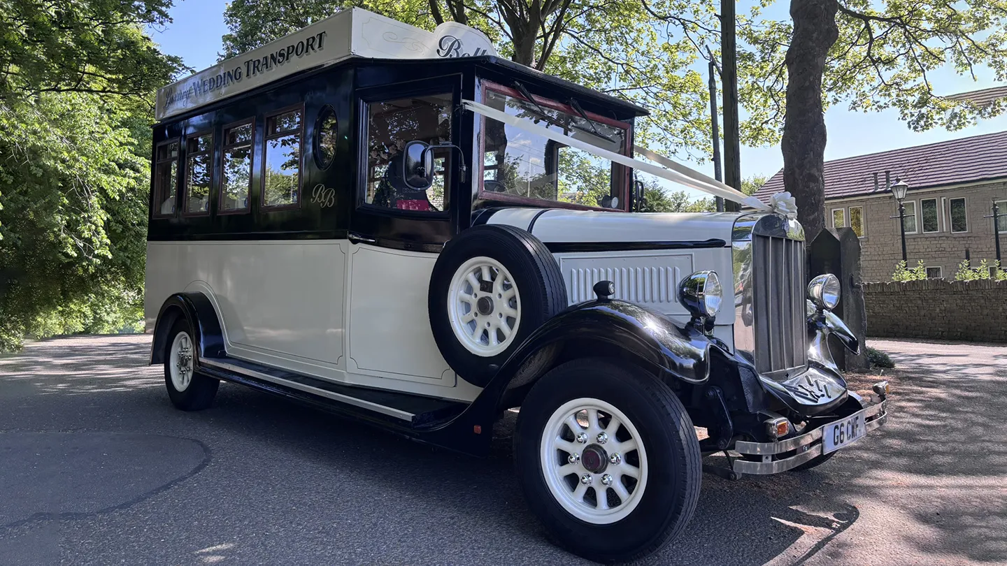 Vinatge Asquith Bus in Bl;ack and White with spare wheel mounted on side of the bus