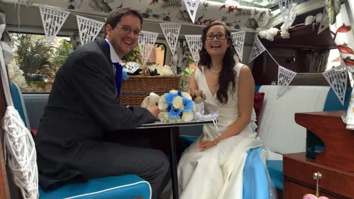 Bride and Groom seating inside a classic VW Campervan