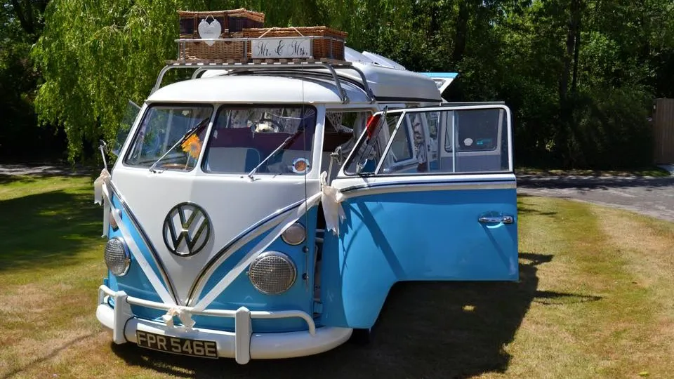 Classic VW campervan in Blue and White with retro decoration on top