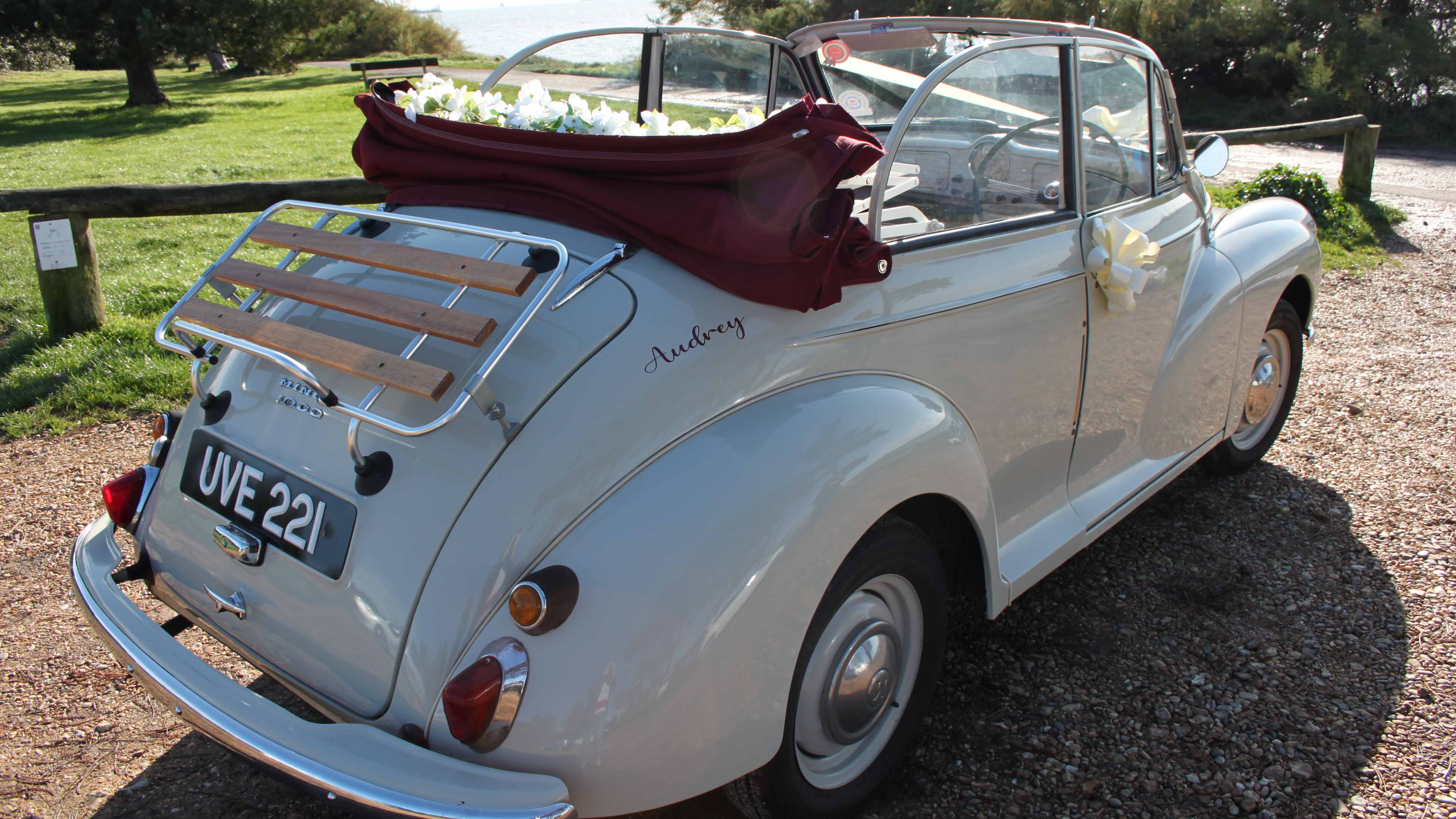 Rear riught view of classic Morris Minor Convertible with opened up soft top roof and chrome bumper