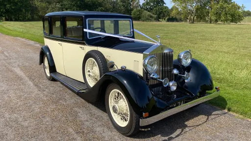 Black and ivory Rolls-Royce 20/25 decorated with white wedding ribbons