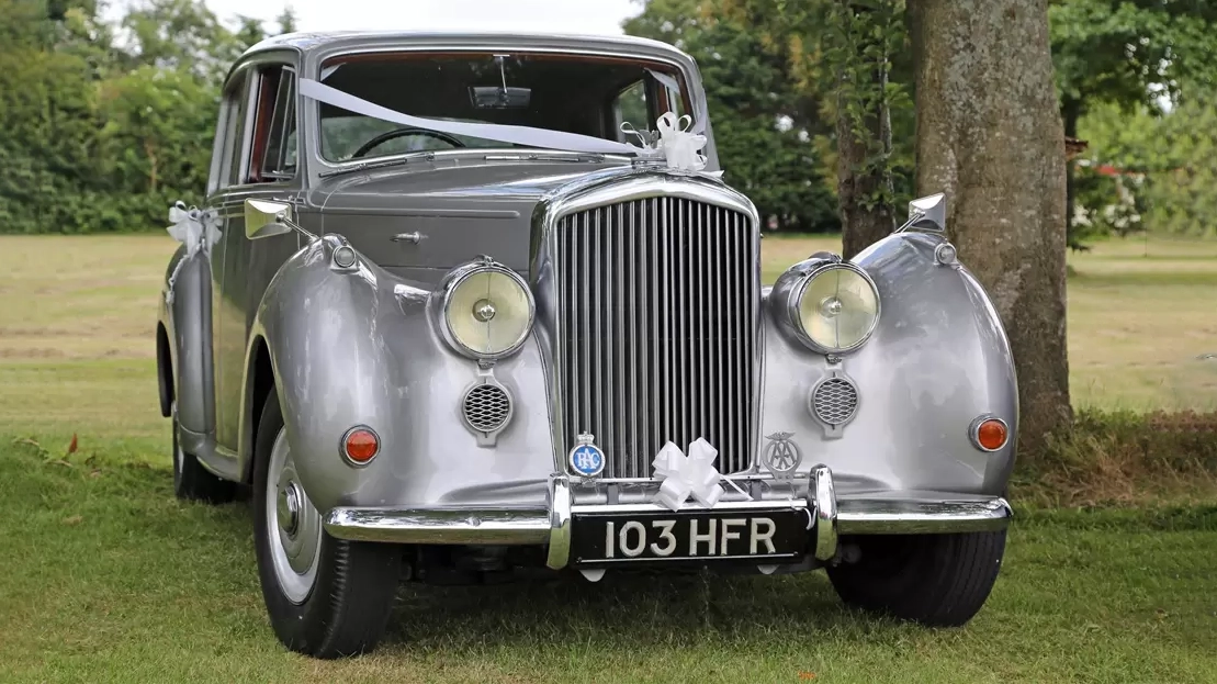 Front view of a silver Bentley R-Type with large round headlamps and upright grille