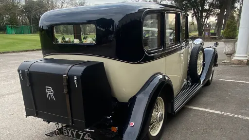 Rear view of a black and ivory vintage Rolls-Royce 20/25 limousine